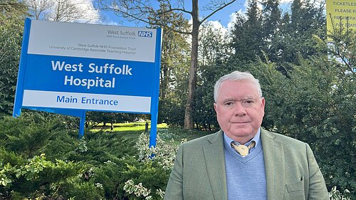 Peter McDonald standing in front of West Suffolk Hospital