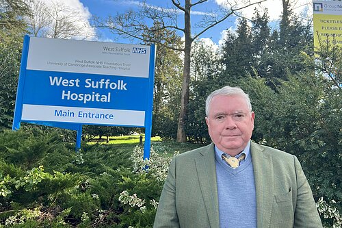 Peter McDonald standing in front of West Suffolk Hospital